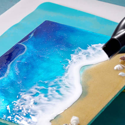 Christine making waves in resin using a hairdryer