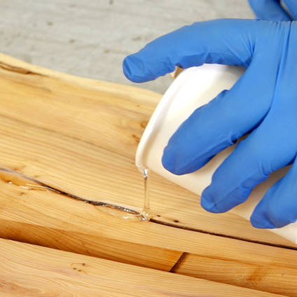 Pouring Epoxy into a Knot in Wood